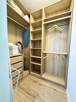 a walk in closet with wood paneling and shelves at Downtown Gem in Plovdiv