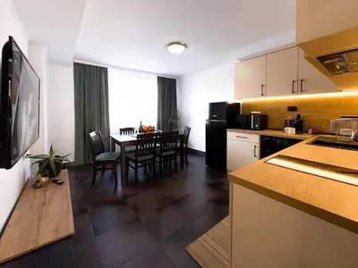 a kitchen and dining room with a table and chairs at Serenity Apartment Bansko in Bansko