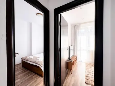 a bedroom with a bed and a mirror at Serenity Apartment Bansko in Bansko