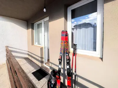 a pair of skis are leaning against a window at Serenity Apartment Bansko in Bansko
