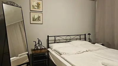 a bedroom with a bed with white sheets and a mirror at Colorful 2BD Apartment next to Serdika Center by Flat Mаnager in Sofia