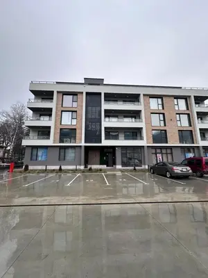 a large building with a parking lot in front of it at July apartaments in Velingrad