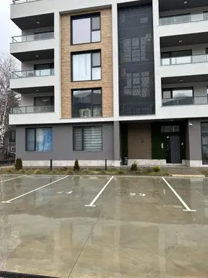 an empty parking lot in front of a building at July apartaments in Velingrad
