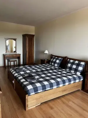 a bedroom with a bed with a checkered blanket at Apartment Geronimo in Pamporovo