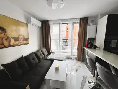 a living room with a couch and a table at Sirius Apartment in Sofia