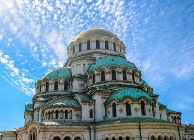 a large building with a domed building with a sky at Sirius Apartment in Sofia
