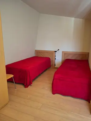 two beds in a small room with red sheets at Maisonette Mountain View - Euphoria Resort in Borovets