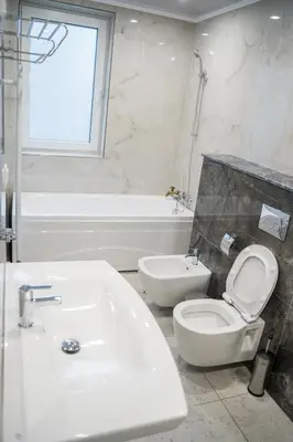 a bathroom with a sink and a toilet and a tub at Хотелски комплекс Релакс in Rudozem