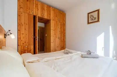 a bedroom with two beds and a wooden wall at A central retreat in the heart of Sofia in Sofia