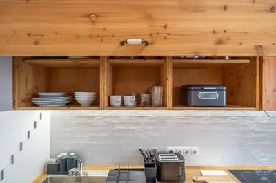 a kitchen with a counter with a microwave and plates at A central retreat in the heart of Sofia in Sofia