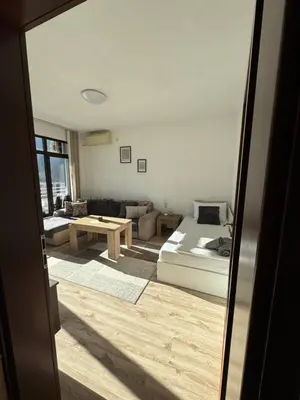 a living room with a bed and a couch at Апартамент Слънчев дом in Smolyan