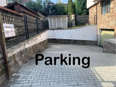 a brick driveway with the words parking written in black at Elegant Two Bedroom Apartment - Top Location in Bansko