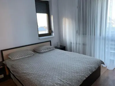 a bed with two pillows in a bedroom with a window at Elegant Two Bedroom Apartment - Top Location in Bansko
