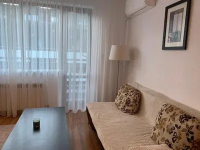 a living room with a couch and a table at Elegant Two Bedroom Apartment - Top Location in Bansko