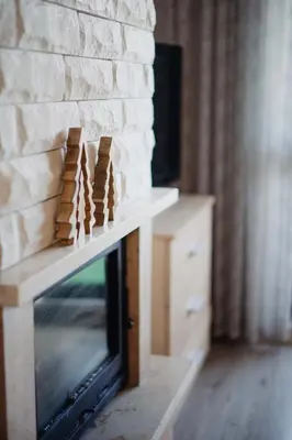 a fireplace with a stack of dominoes on top of it at Pirin Peaks Residence - next to Ski Lift in Bansko