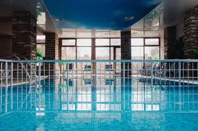 a swimming pool with blue water in a building at Rila Residence - next to Pirin Golf in Razlog