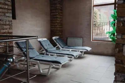 a row of chairs in a room with a window at Rila Residence - next to Pirin Golf in Razlog
