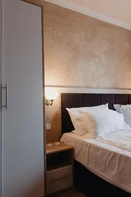 a bedroom with a bed with a mirror next to it at Rila Residence - next to Pirin Golf in Razlog
