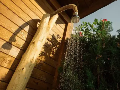 a wooden fence with a shower in a garden at Villa Leventy in Banya