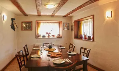a dining room with a wooden table and chairs at Villa Leventy in Banya