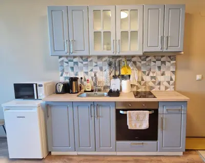 a kitchen with white cabinets and a sink at Cosy n fully equipped studio in Samokov