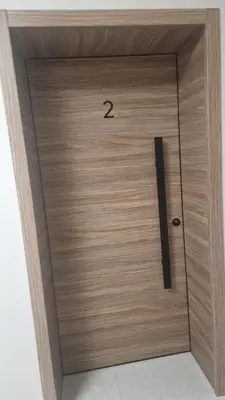 a wooden door with the number on it at Concrete comfort in Samokov