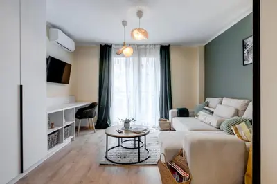 a living room with a couch and a table at Veslets 4 Oldtown Stay in Sofia