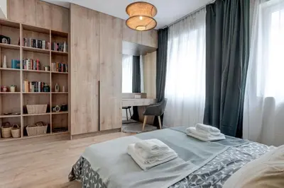 a bedroom with a bed with two towels on it at Veslets 4 Oldtown Stay in Sofia