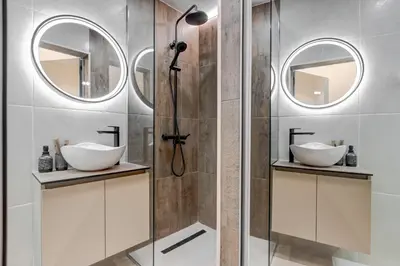 a bathroom with two sinks and two mirrors at Veslets 4 Oldtown Stay in Sofia
