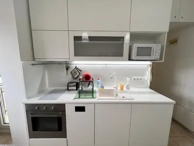 a white kitchen with a sink and a microwave at Florence family 2BDR Apt - min from Serdika w WiFi in Sofia