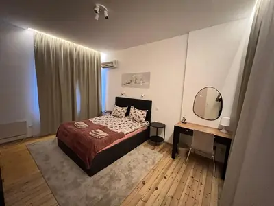 a bedroom with a bed and a desk and a mirror at Florence family 2BDR Apt - min from Serdika w WiFi in Sofia