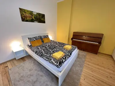 a bedroom with a bed and a piano at Florence family 2BDR Apt - min from Serdika w WiFi in Sofia