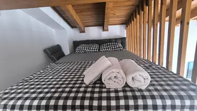 a bedroom with a bed with towels on it at FEDORA - Luxury Penthouse in Pirin Golf & SPA in Razlog