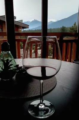 a wine glass sitting on top of a table at FEDORA - Luxury Penthouse in Pirin Golf & SPA in Razlog