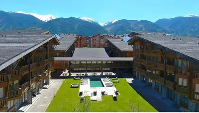 an aerial view of a building with mountains in the background at FEDORA - Luxury Penthouse in Pirin Golf & SPA in Razlog