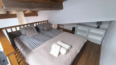 a bedroom with a large bed with towels on it at FEDORA - Luxury Penthouse in Pirin Golf & SPA in Razlog