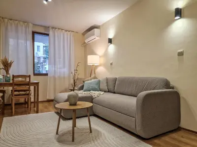 a living room with a couch and a table at Relaxing Stay in Kosara Bansko Near Ski Lift by Flat Mаnager in Bansko