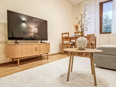 a living room with a tv and a table at Relaxing Stay in Kosara Bansko Near Ski Lift by Flat Mаnager in Bansko