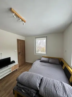 a bedroom with a bed and a flat screen tv at Вила Mountain Ship in Dedovo