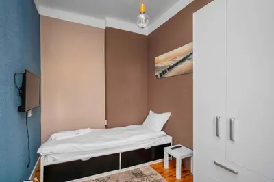 a small room with a bed and a painting on the wall at Cozy and Central 2BD Flat - At the Heart of It All by Flat Mаnager in Sofia