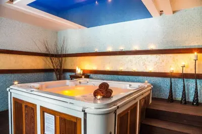a large bath tub in a room with lights at Bansko lodge 500m from ski lift in Bansko