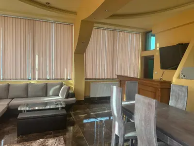 a living room with a couch and a table at arartment in Kostandovo