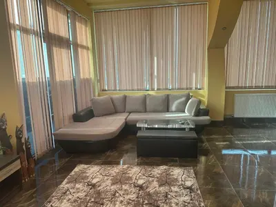 a living room with a couch and a table at arartment in Kostandovo