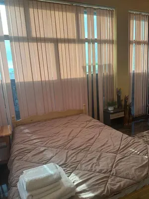 a bed with two towels on it in a bedroom at arartment in Kostandovo