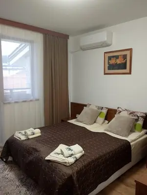 a hotel room with two beds with towels on them at Двустаен апартамент 