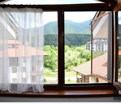 a window with a view of a mountain at Двустаен апартамент 