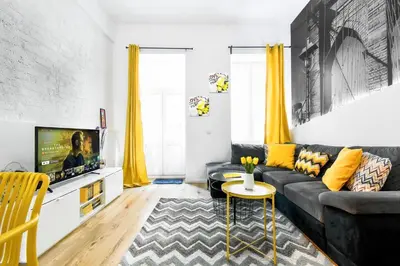 a living room with a couch and a tv at Center Stay Stylish 2BR near Serdika Metro in Sofia
