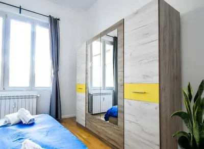 a bedroom with a large mirror and a bed at Center Stay Stylish 2BR near Serdika Metro in Sofia