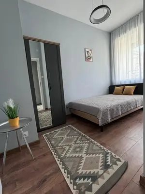 a bedroom with a bed and a mirror and a table at Боко 16-18 in Sofia
