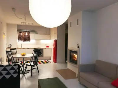 a living room with a couch and a table with a fireplace at Host2U Art AP - Fireplace - Free parking - 5min Gondola in Bansko